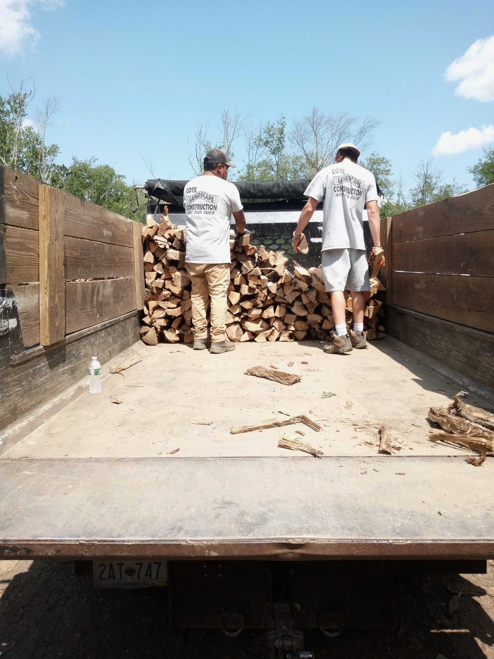 Cote Landscape crew securing the tarp over the firewood load before delivery